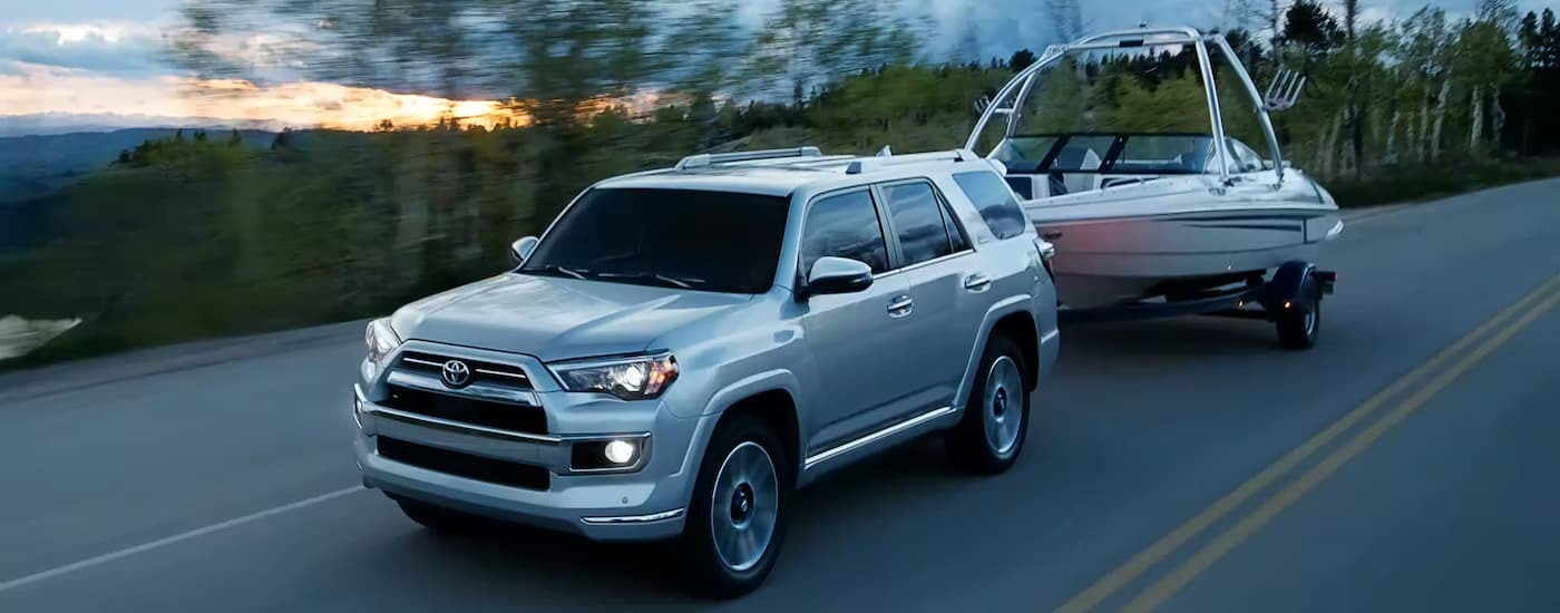 A silver 2023 Toyota 4Runner Limited towing a boat after viewing SUVs for sale near Union City.