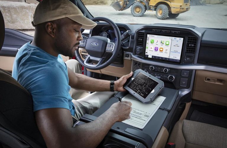 One man is working while sitting inside a 2023 Ford F-150