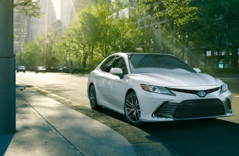 Toyota Camry parked on a city road near a building