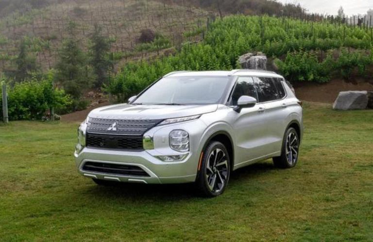 2024 Mitsubishi Outlander parked on a grassy area off-road