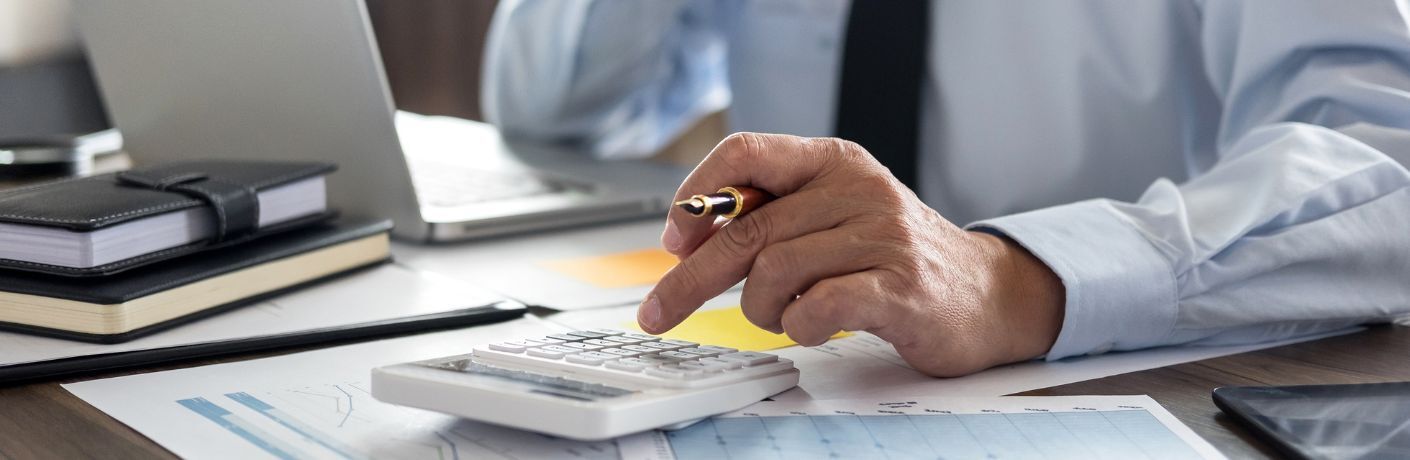 man making calculations with respect to his financing options