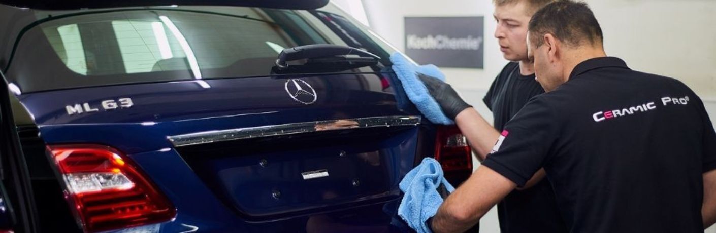 2 technicians wiping the rear of a Mercedes-Benz
