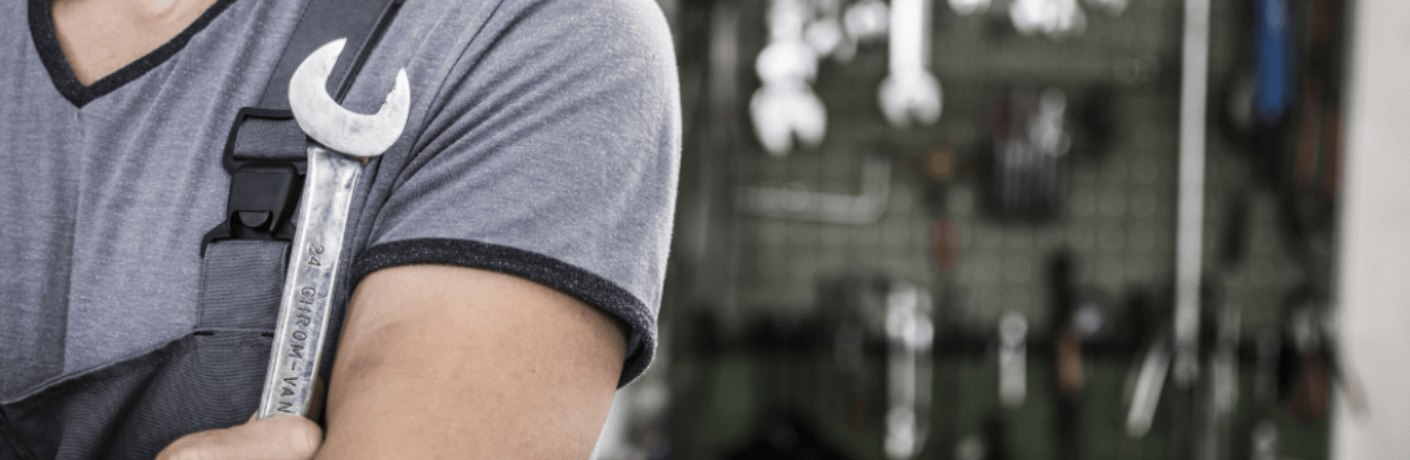 Mechanic posing with a tool