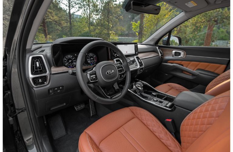 2021 Kia Sorento interior shot of front seating, steering wheel, and dashboard layout