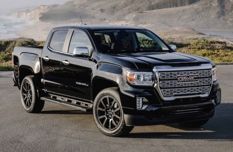 front view image of a GMC truck parked on a road