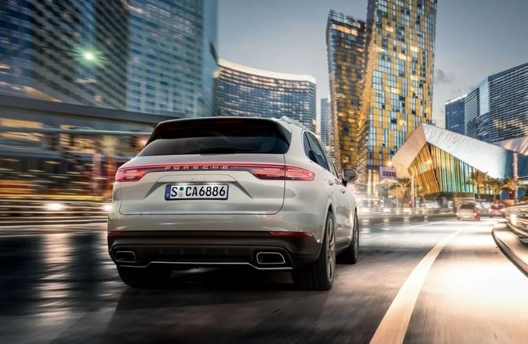 Rear view of a white 2022 Porsche Cayenne on a road
