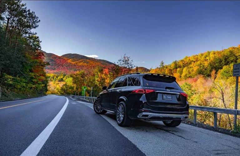a Mercedes-Benz SUV on a road
