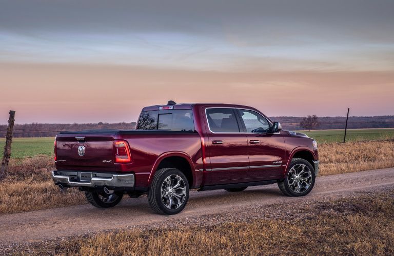 The rear of the 2022 Ram 1500 driving in a farm