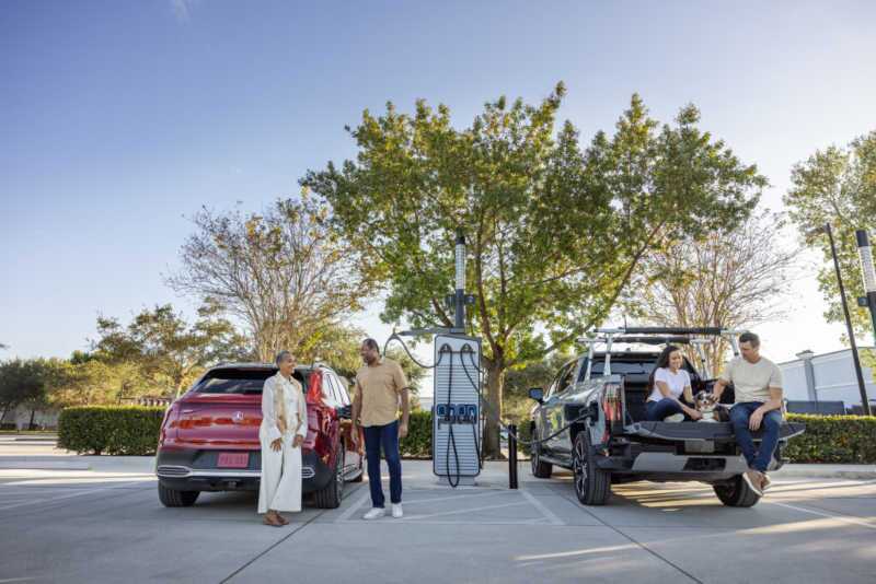 Two vehicles at an 800V charging hub near Scottsdale