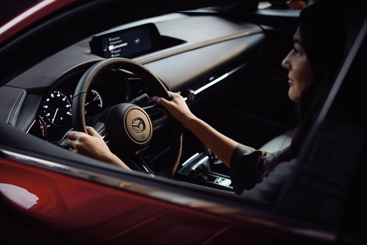 A woman behind the wheel of a Mazda CX-30 in San Juan, CA