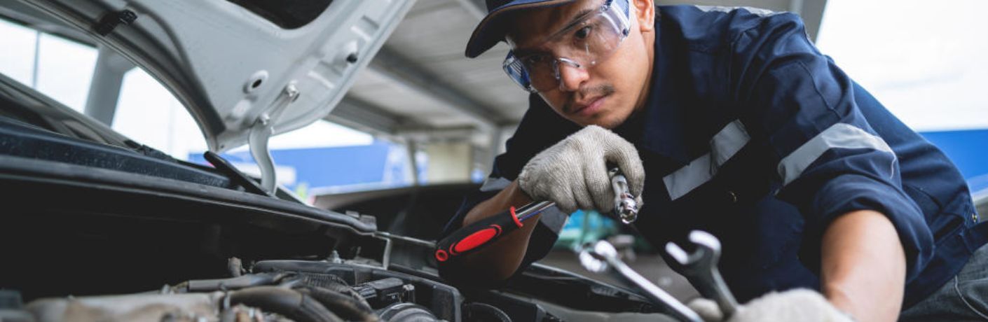 A mechanic working on a vehicle