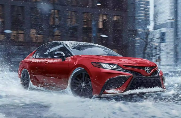 2023 Toyota Camry driving through the road