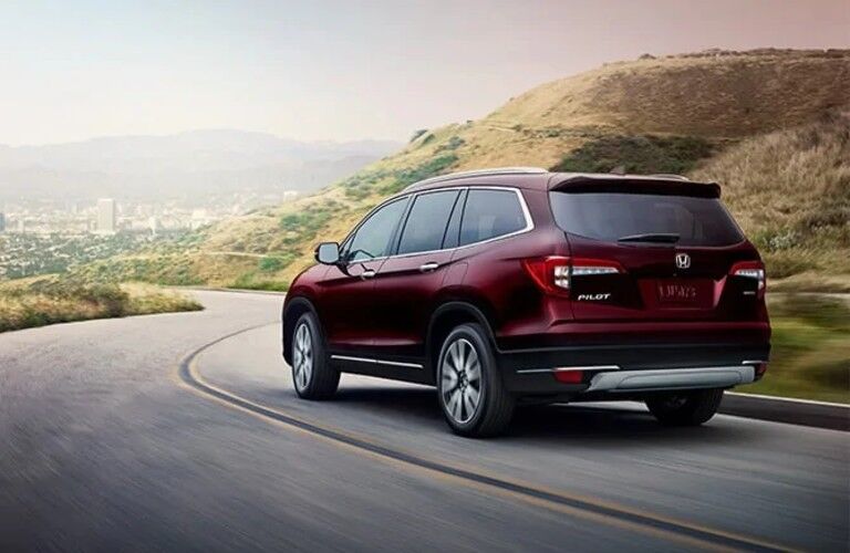 Rear driver angle of a red 2021 Honda Pilot