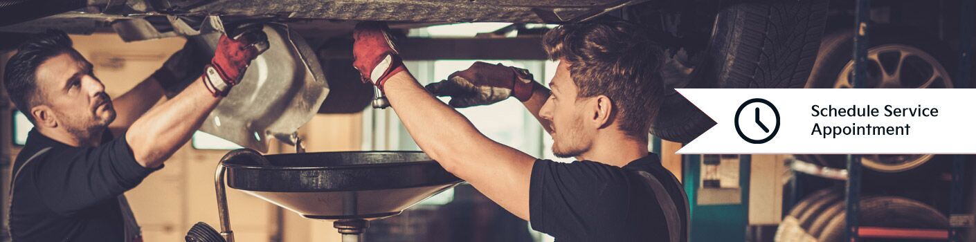 mechanics working under car