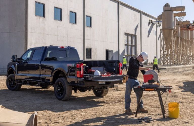 rear and side view of a Ford F-250 at a construction site