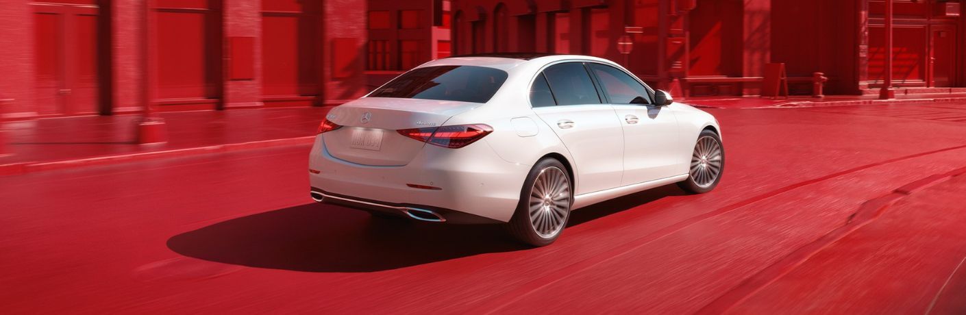 rear view of a 2026 Mercedes-Benz C-Class Sedan in a red world