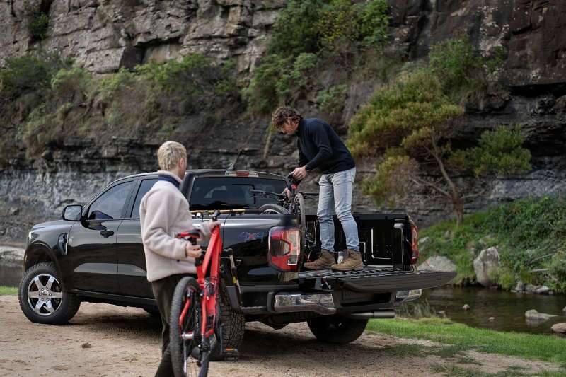 Two men using the cargo bed in the 2025 Ford Ranger.