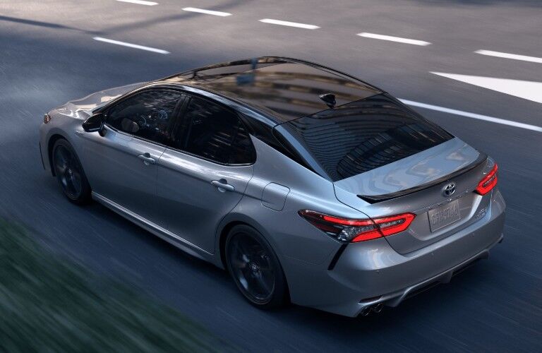 Rear driver angle of a grey 2021 Toyota Camry Hybrid