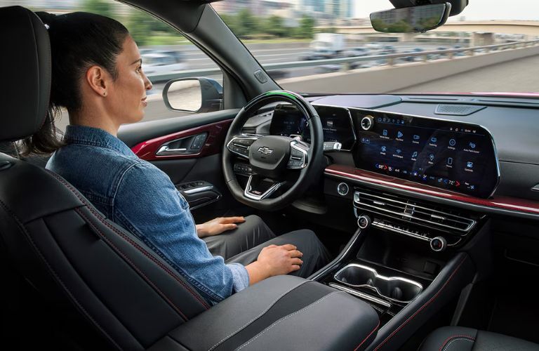 A woman sitting on driver's seat of the 2026 Chevrolet Traverse