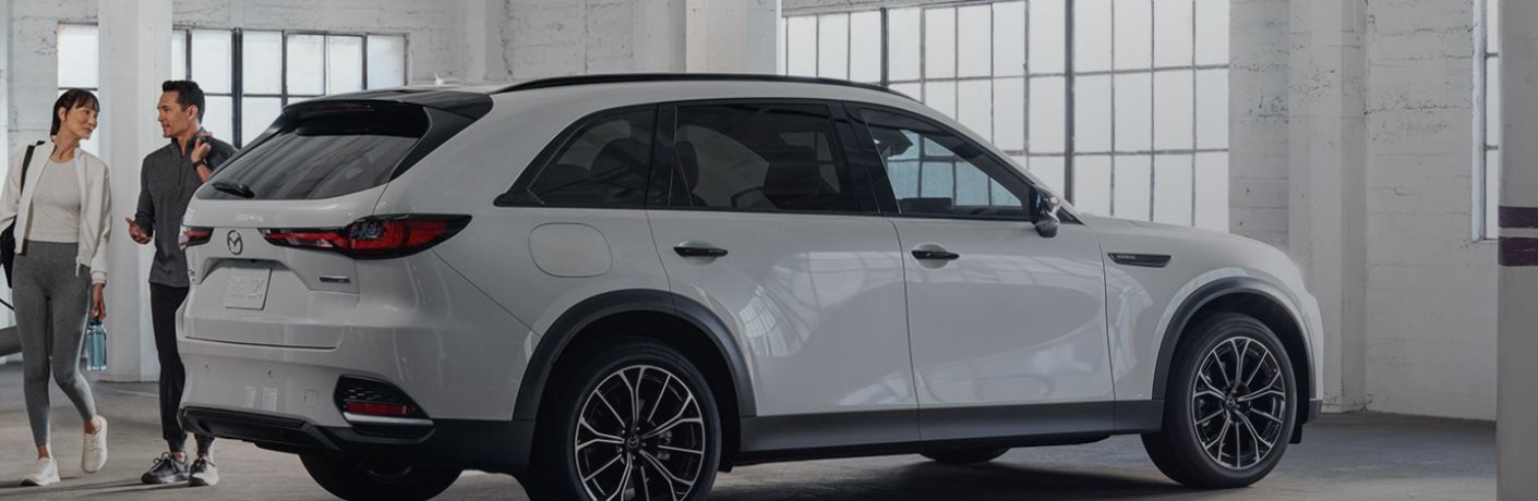 Couple walking out of the 2025 Mazda CX-70 PHEV