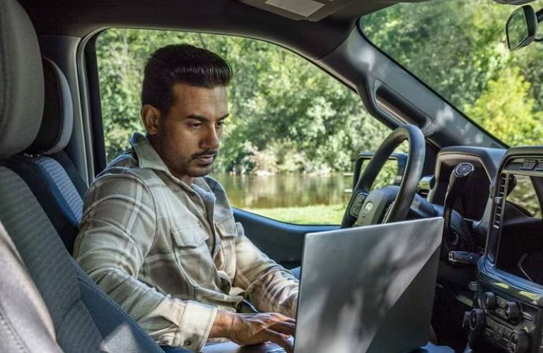 2025 Ford F-150 XL with a driver inside