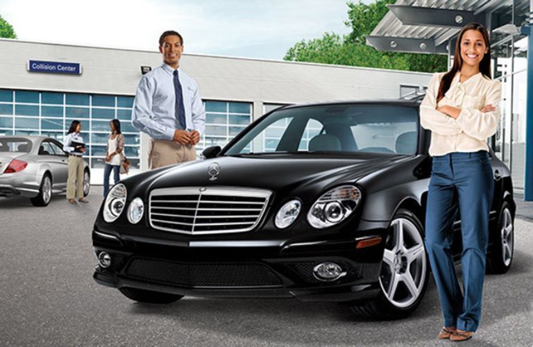 People posing in front of Mercedes-Benz collision center