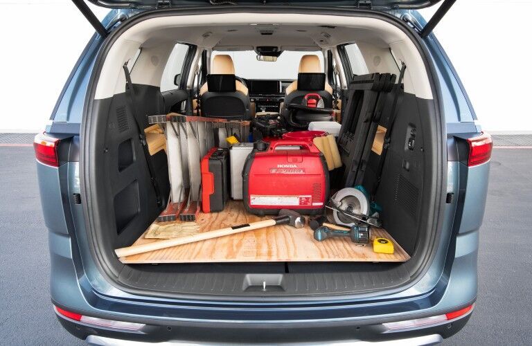 The cargo area in the 2022 Kia Carnival filled with home repair equipment.