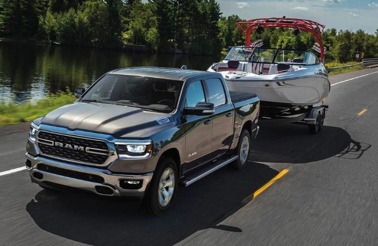 2023 Ram 1500 Blue towing a boat