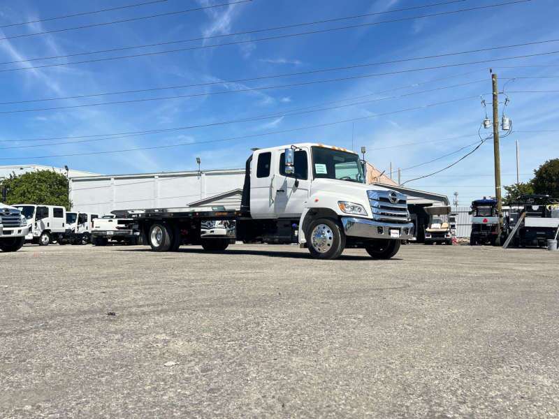A side exterior view of a flatbed tow truck