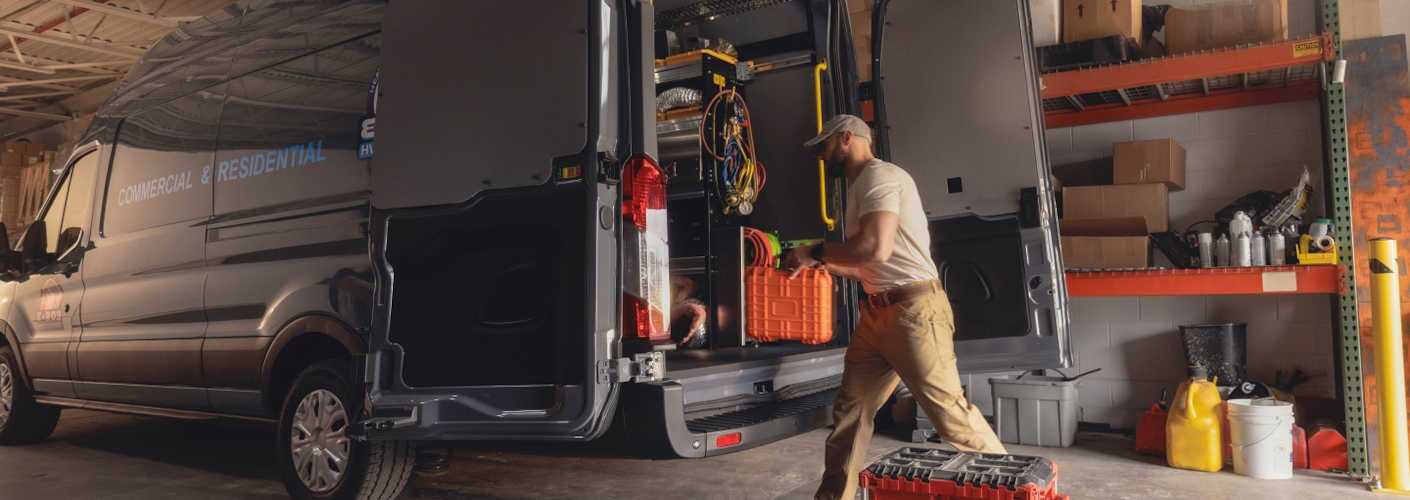A Ford E-Transit van used in a commercial repair busines