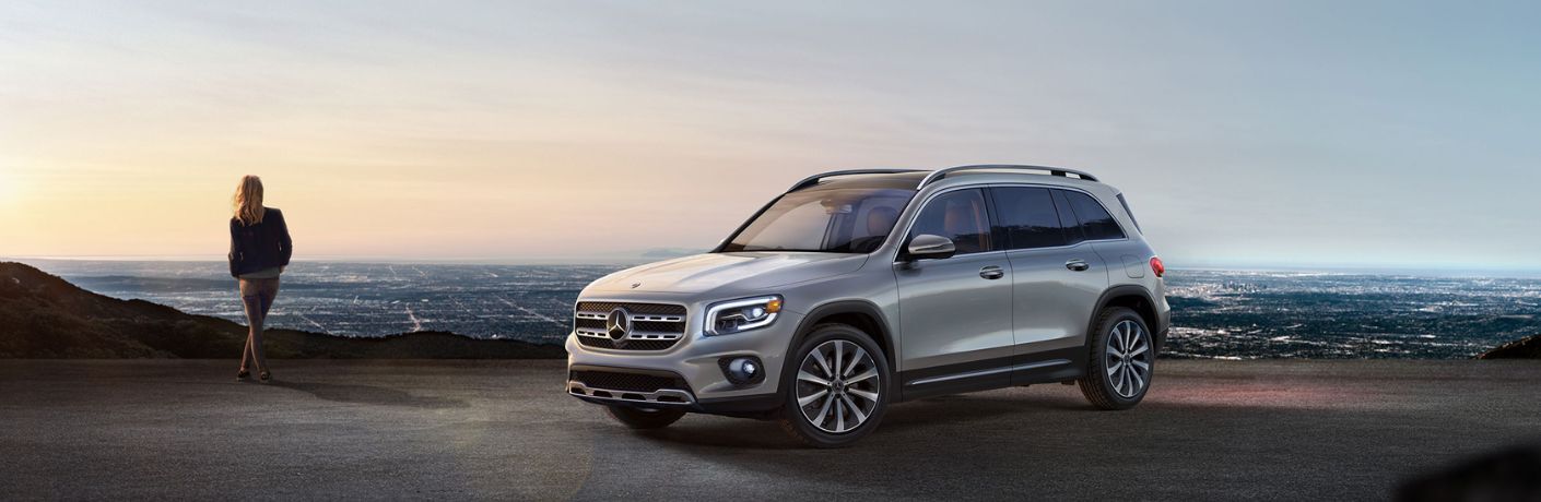 woman standing next to the 2023 Mercedes-Benz GLB 250 SUV