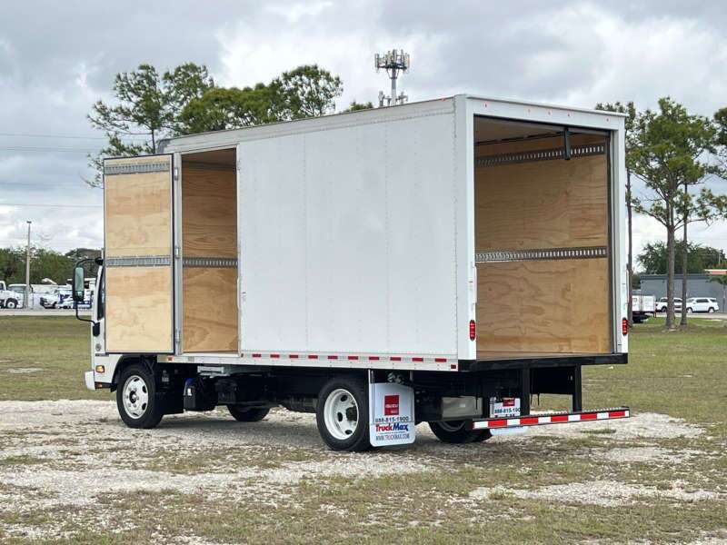 A rear quarter exterior view of a box truck with its doors open
