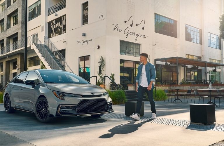 Toyota Corolla parked near a building