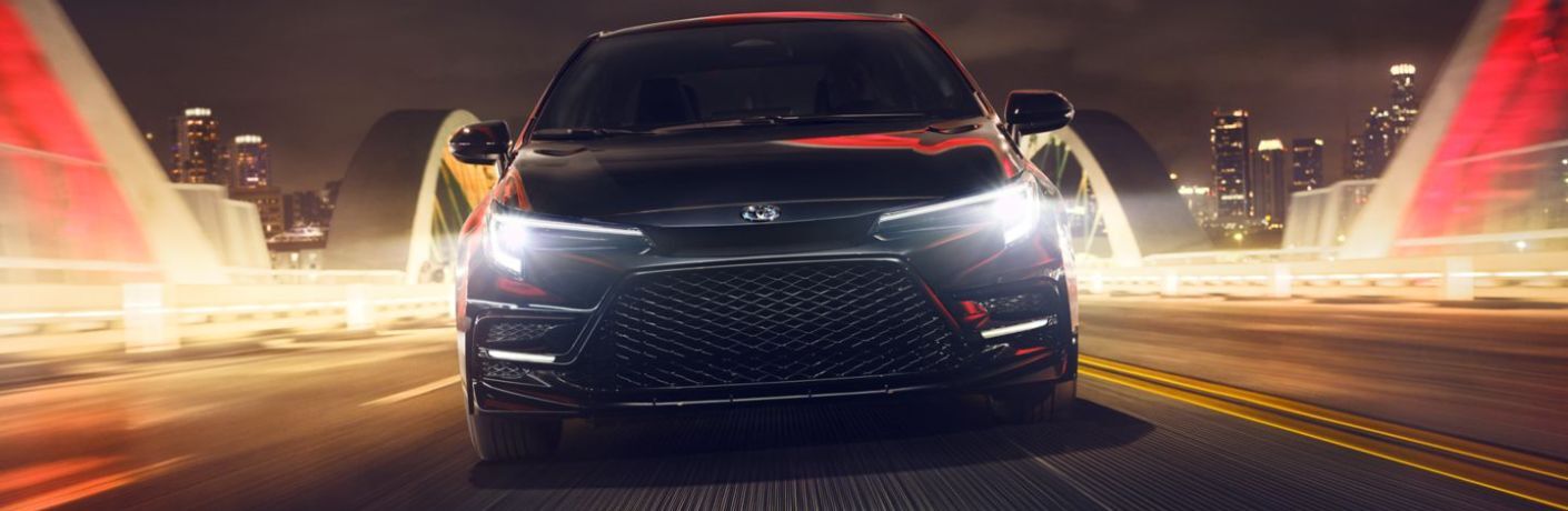 Front view of a 2024 Toyota Corolla speeding on a road