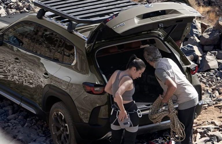 A couple preparing for their adventure with the 2024 Mazda CX-50