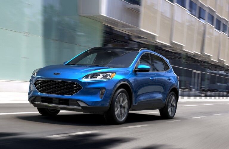 Front driver angle of a blue 2020 Ford Escape driving down a road