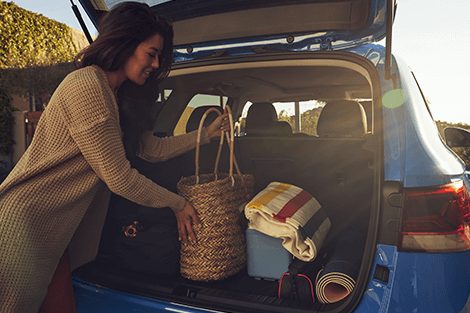 Woman loading the back of a Volkswagen SUV