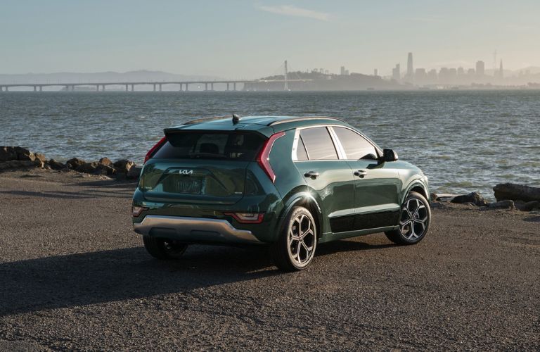 rear view image of the 2025 Kia Niro Hybrid parked near a lake