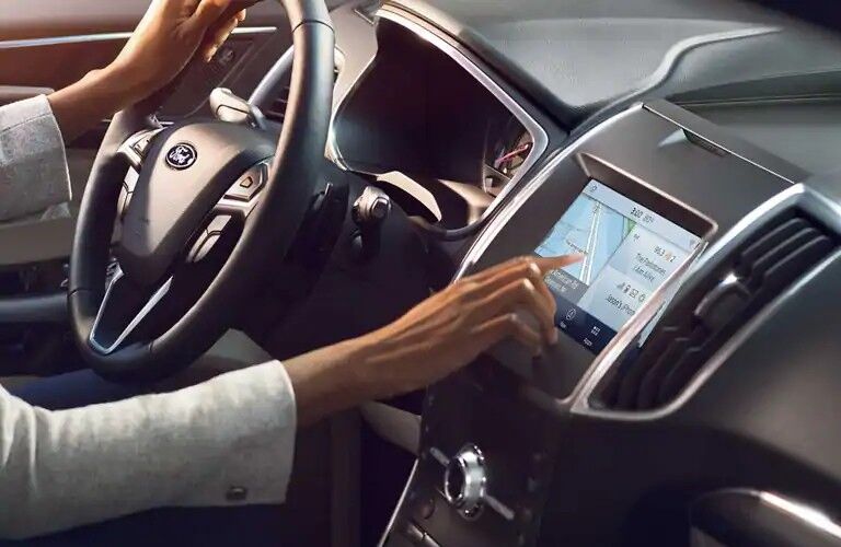 Woman operating touchscreen of 2020 Ford Edge SE