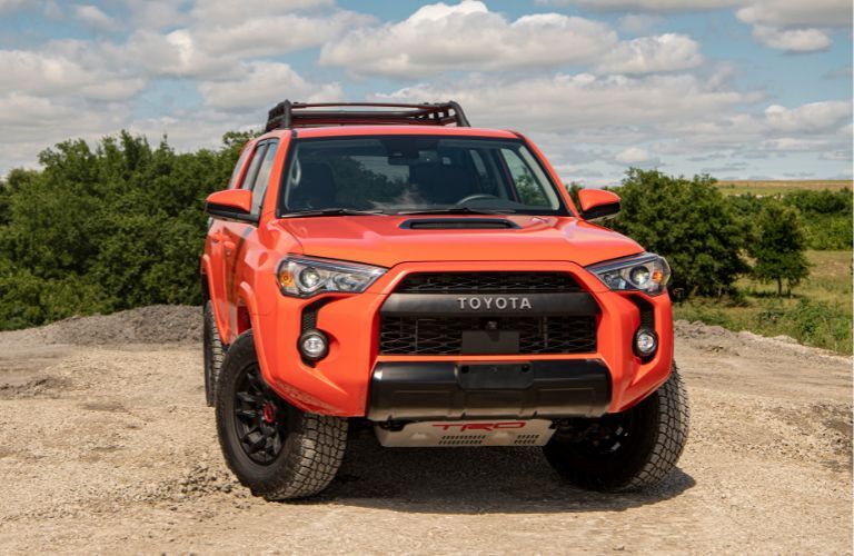 2023 Toyota 4Runner front view with lush green trees in the background