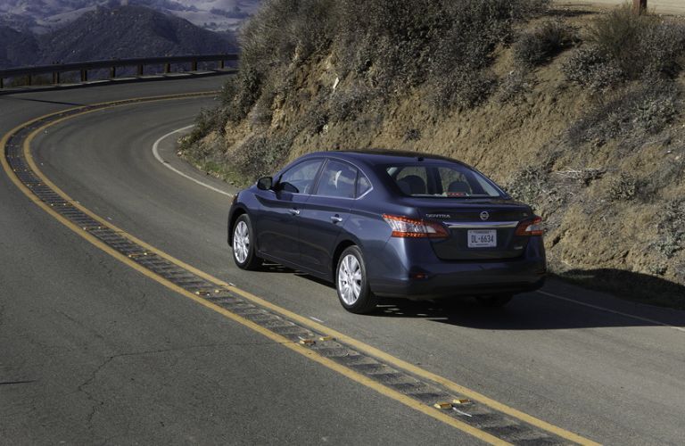 Rear view of the 2014 Nissan Sentra driving on road