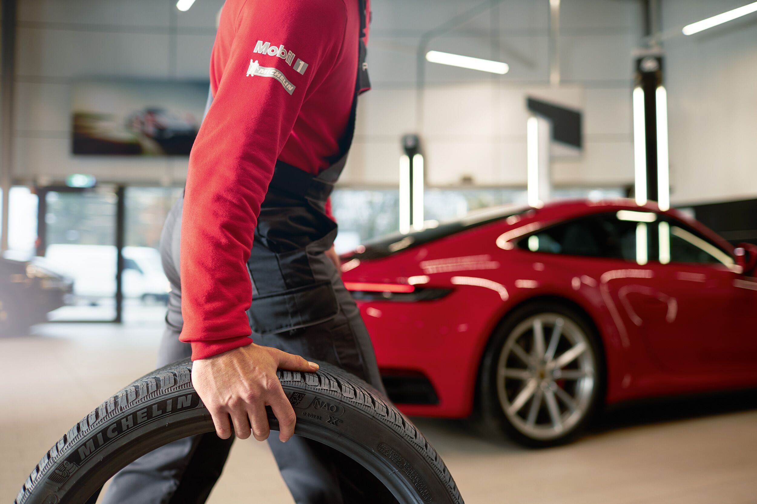 porsche certified technician rolling a porsche michelin tire