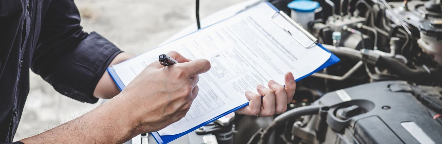 A service technician conduction a multi-point inspection