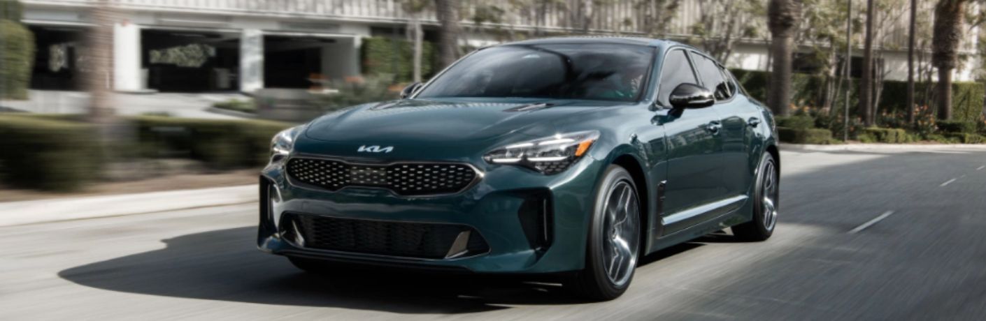 An image of the side view of a blue colored 2023 Kia Stinger