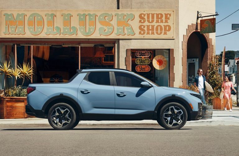 A 2022 Hyundai Santa Cruz parked in front of a surf shop