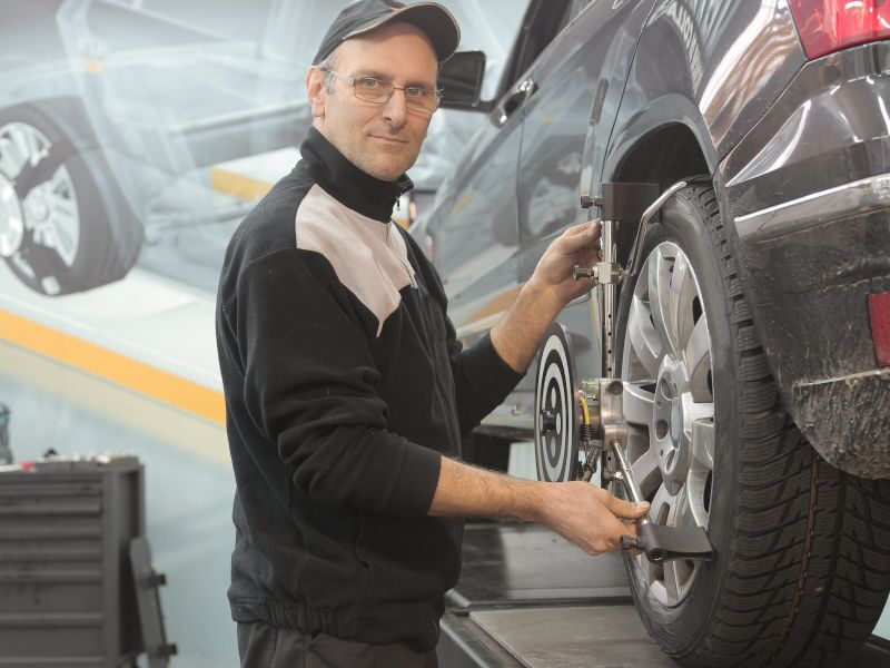 A technician beginning the wheel alignment process near Edmonton, AB.
