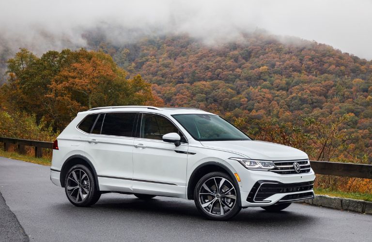 A 2022 Volkswagen Tiguan backdropped by a hill of trees