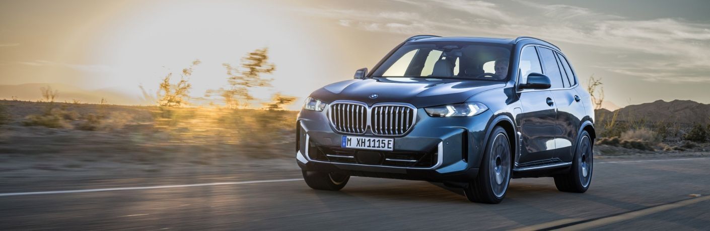 Front three-quarter view of the 2024 BMW X5 driving