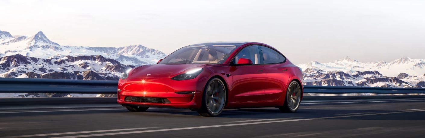 diagonal front view image of a Tesla car on a road
