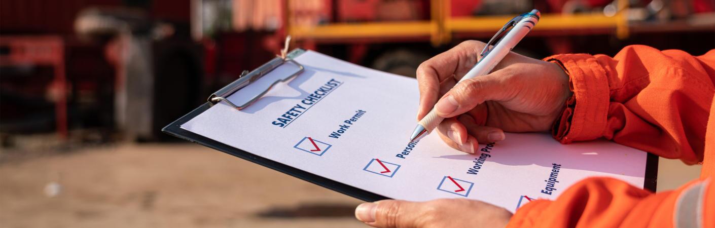 A side view of a used roll off truck for sale at Dirt Cheap Truck Sales in Tampa, FL.